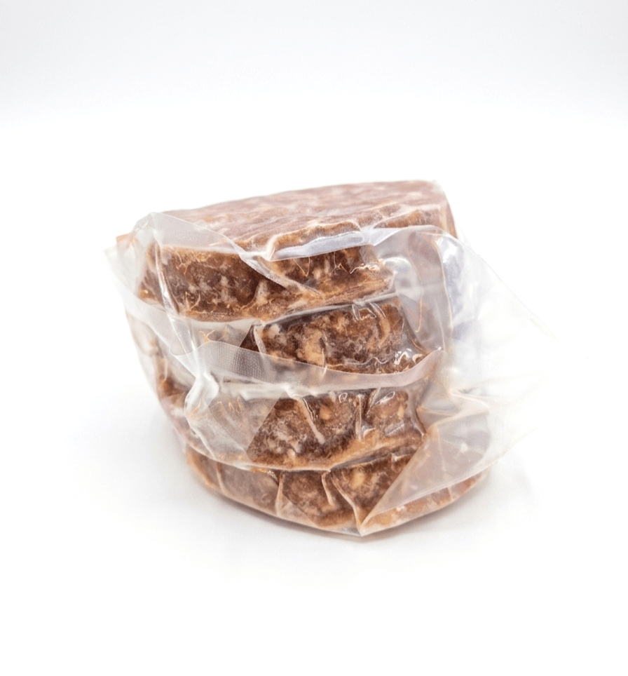 Four stacked Beef Patties 6oz (Frozen) wrapped in clear plastic packaging