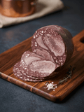 A sliced Blood & Tongue arranged on a wooden cutting board