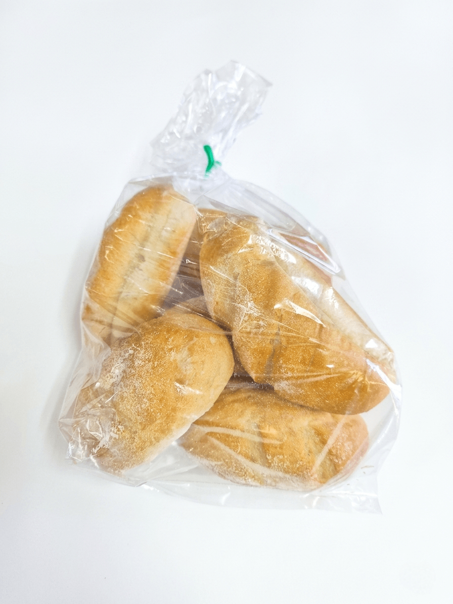 Six Buns sealed in a clear plastic bag with a small green tie