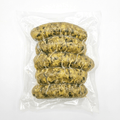 Five of Chicken Spinach Feta Sausage inside a clear plastic vacuum-sealed bag