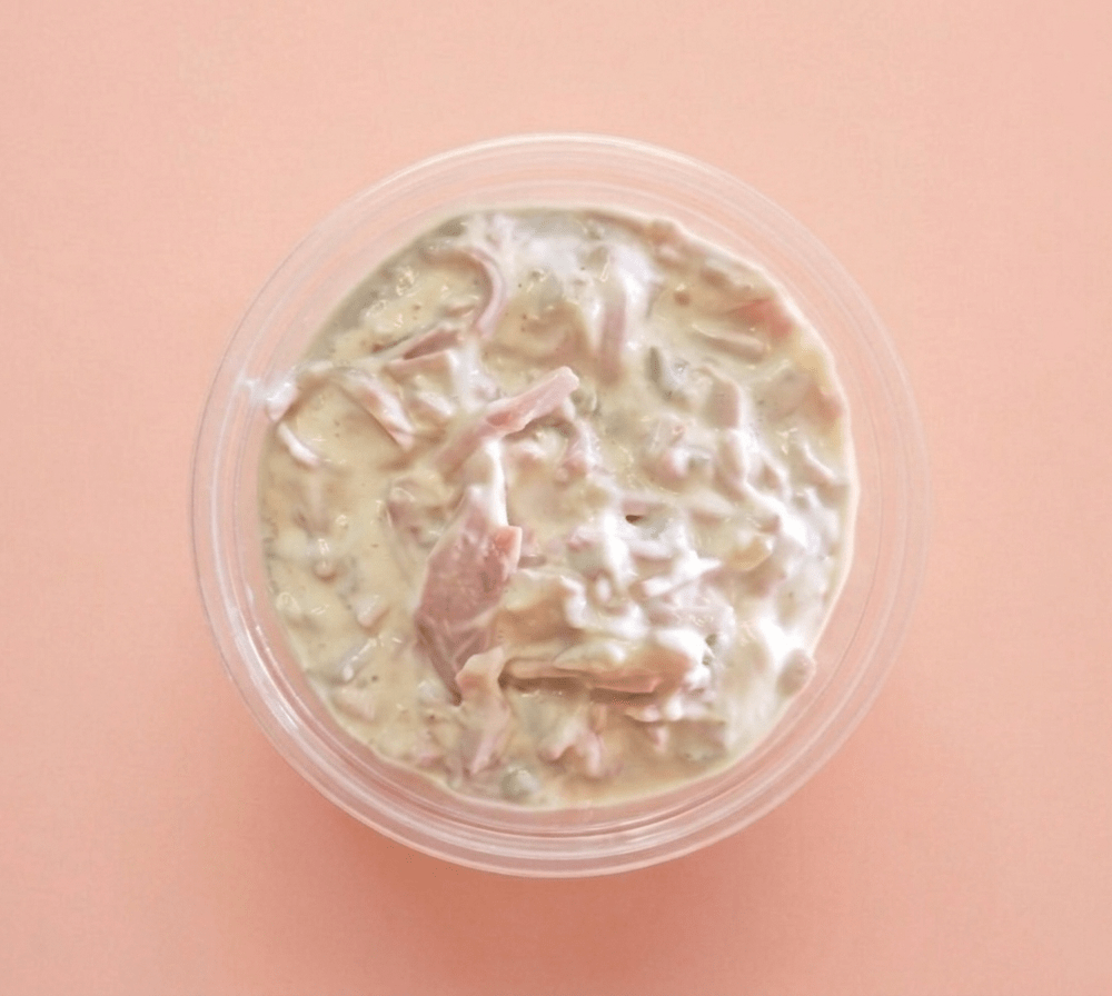A top-down view of Coldcut Salad (Large) in a clear plastic round container