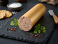 A Fine Liver Sausage with Herbs loaf with a cut end