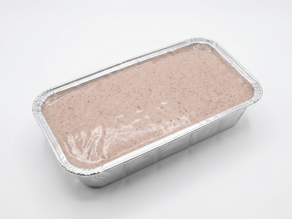 A rectangular aluminum foil tray containing Fine Meatloaf (Raw / Frozen)