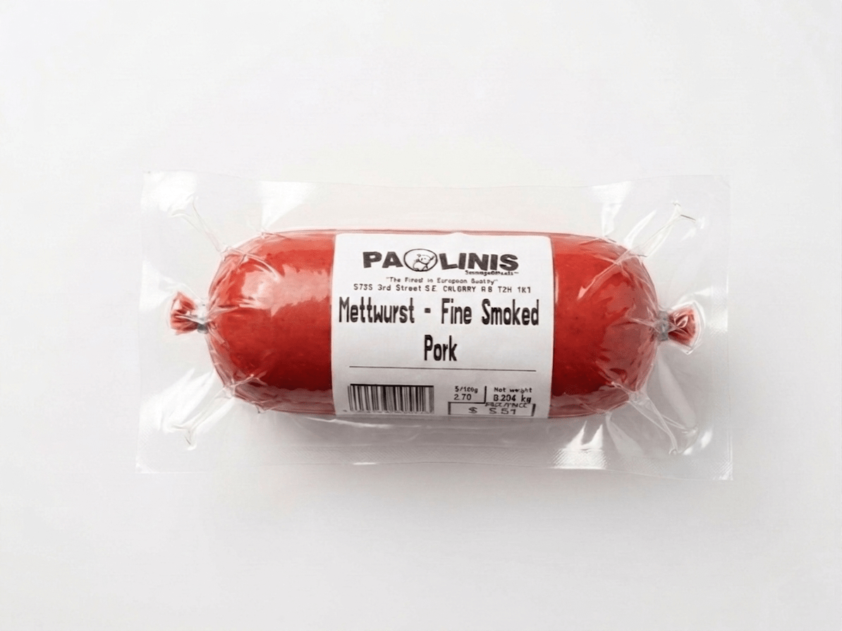The product is labeled 'PAOLINIS Mettwurst - Fine Smoked Pork' and is sealed in clear plastic packaging