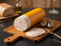 A sliced loaf of Mushroom Lyoner displayed on a wooden cutting board