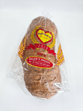 A sliced loaf of brown bread in clear plastic packaging with a red and yellow Helen's Bakery label
