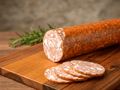 A sliced Smoked Tiroler log with several round slices in front