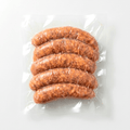 Five Sweet Italian Pork Sausage (Raw / Frozen) in a clear plastic vacuum-sealed bag