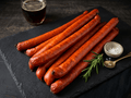 Several Turkey Sticks arranged on a dark slate serving board